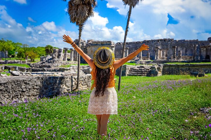Young woman enjoying a sunny day at the Tulum ruins in the Riviera Maya.