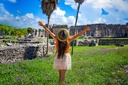 Young woman enjoying a sunny day at the Tulum ruins in the Riviera Maya.