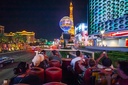 Travelers ready themselves to grab a picture of Las Vegas' take on the Eiffel Tower.